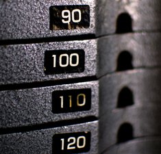 Stack of rusty metal weights in gym bodybuilding equipment